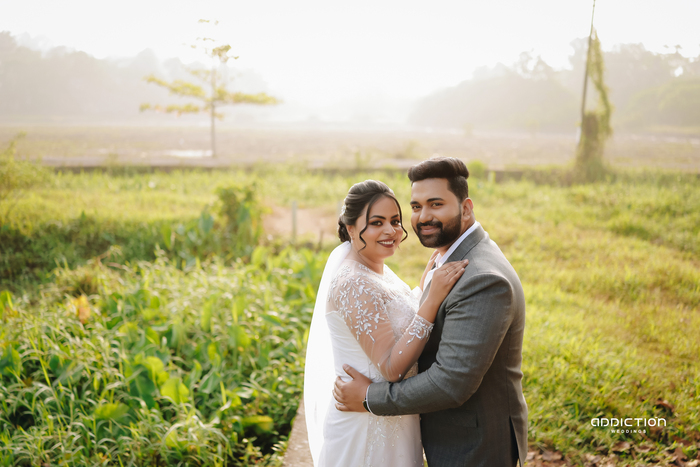 Newlyweds sharing a joyful moment outdoors
